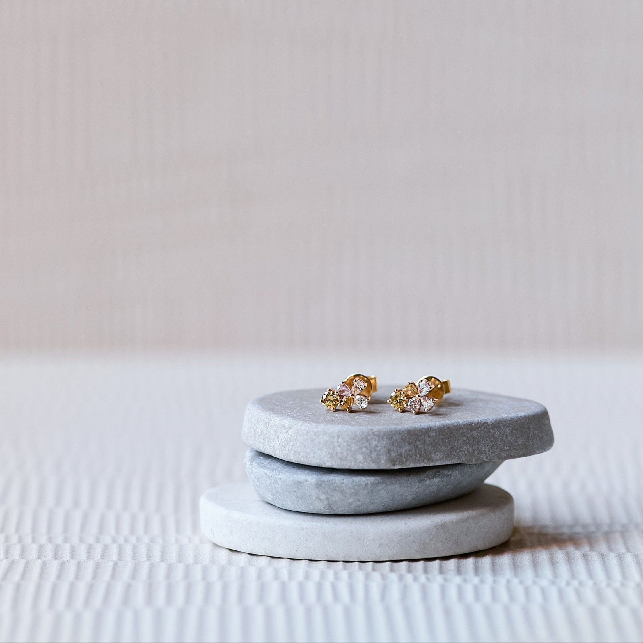 Gradient 18K solid yellow gold and rose gold studs with pink, amber, white and yellow diamonds