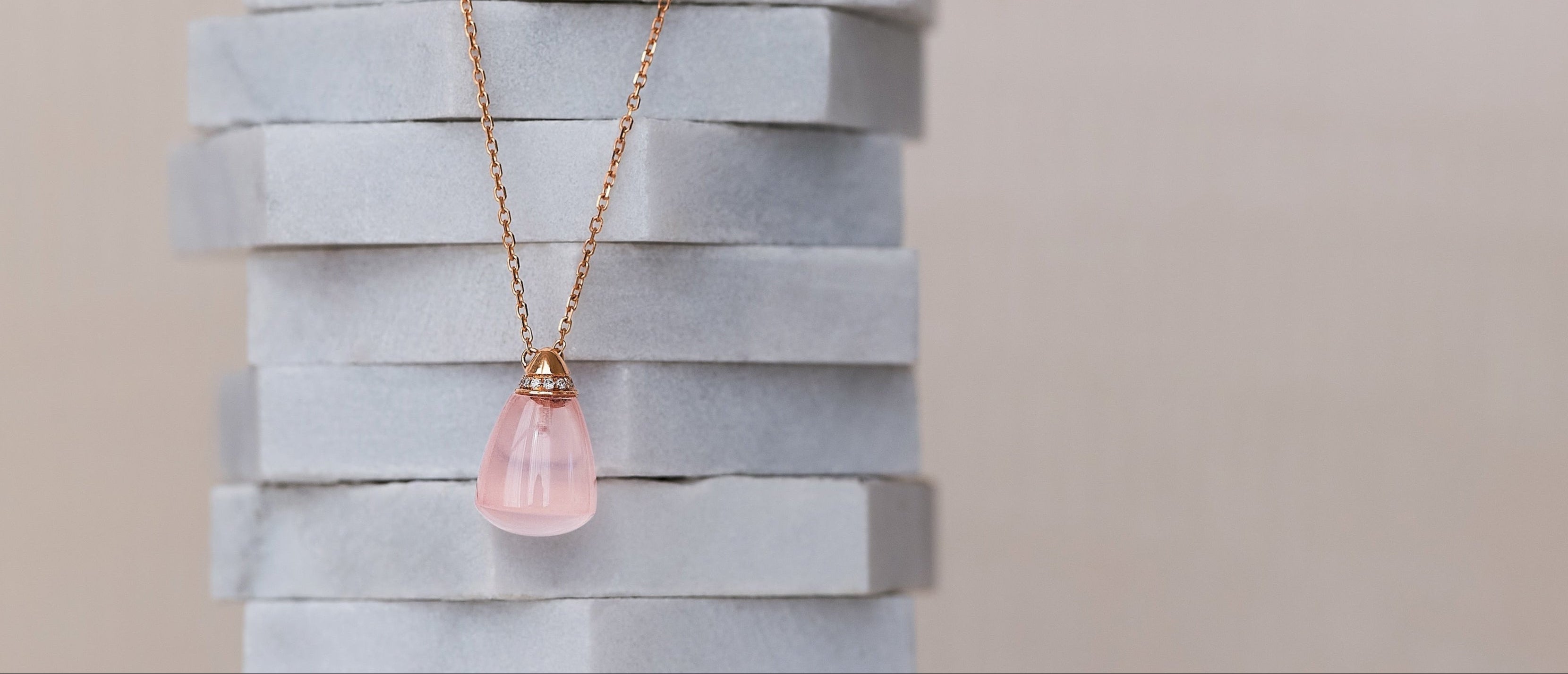 Assorted loose gemstones in various colors on neutral background