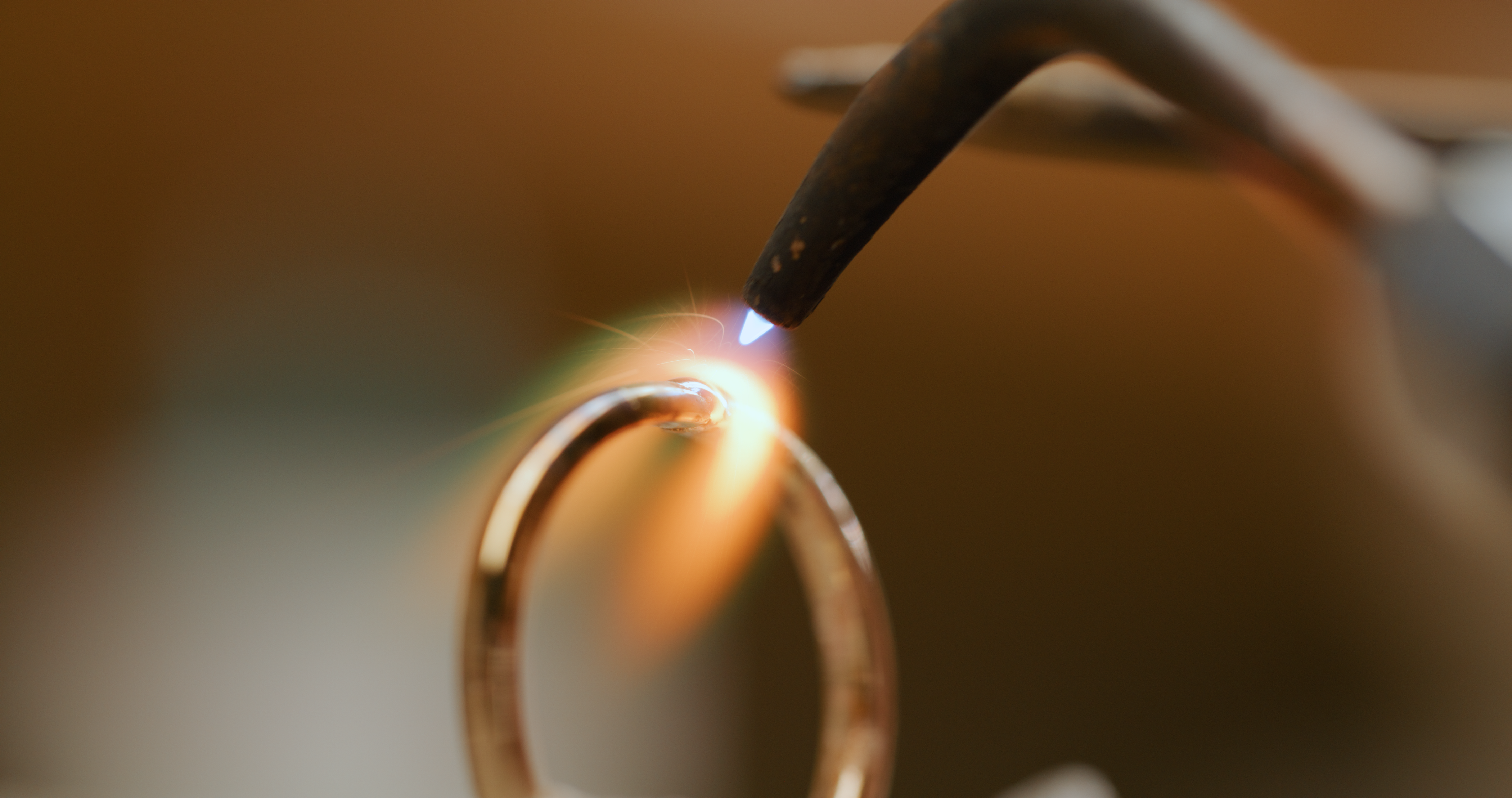 fire torch burning on a close-up of a wedding ring by Vinca jewelry