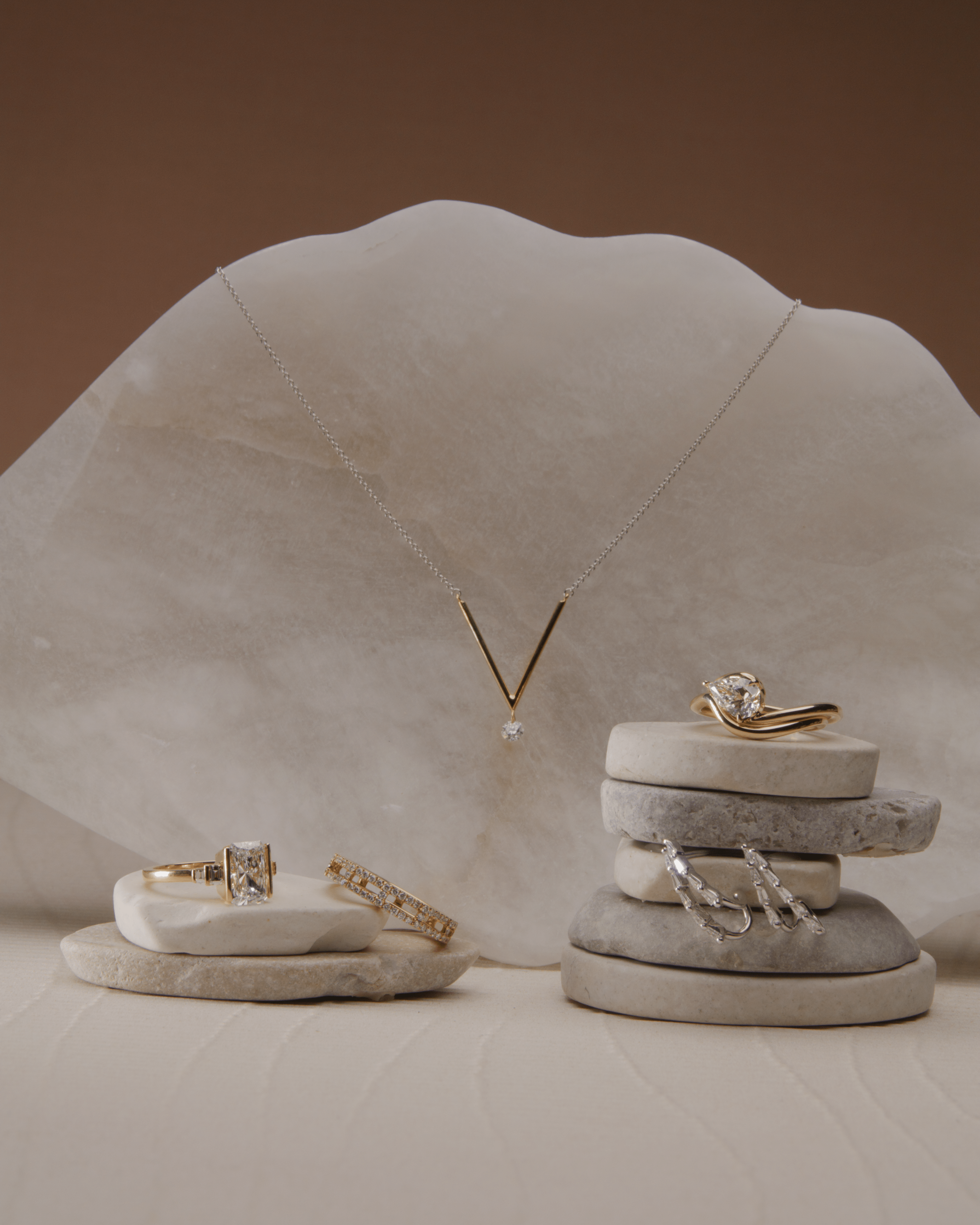 Shape of you collection, jewelry laid on marble, necklace, rings and bracelets