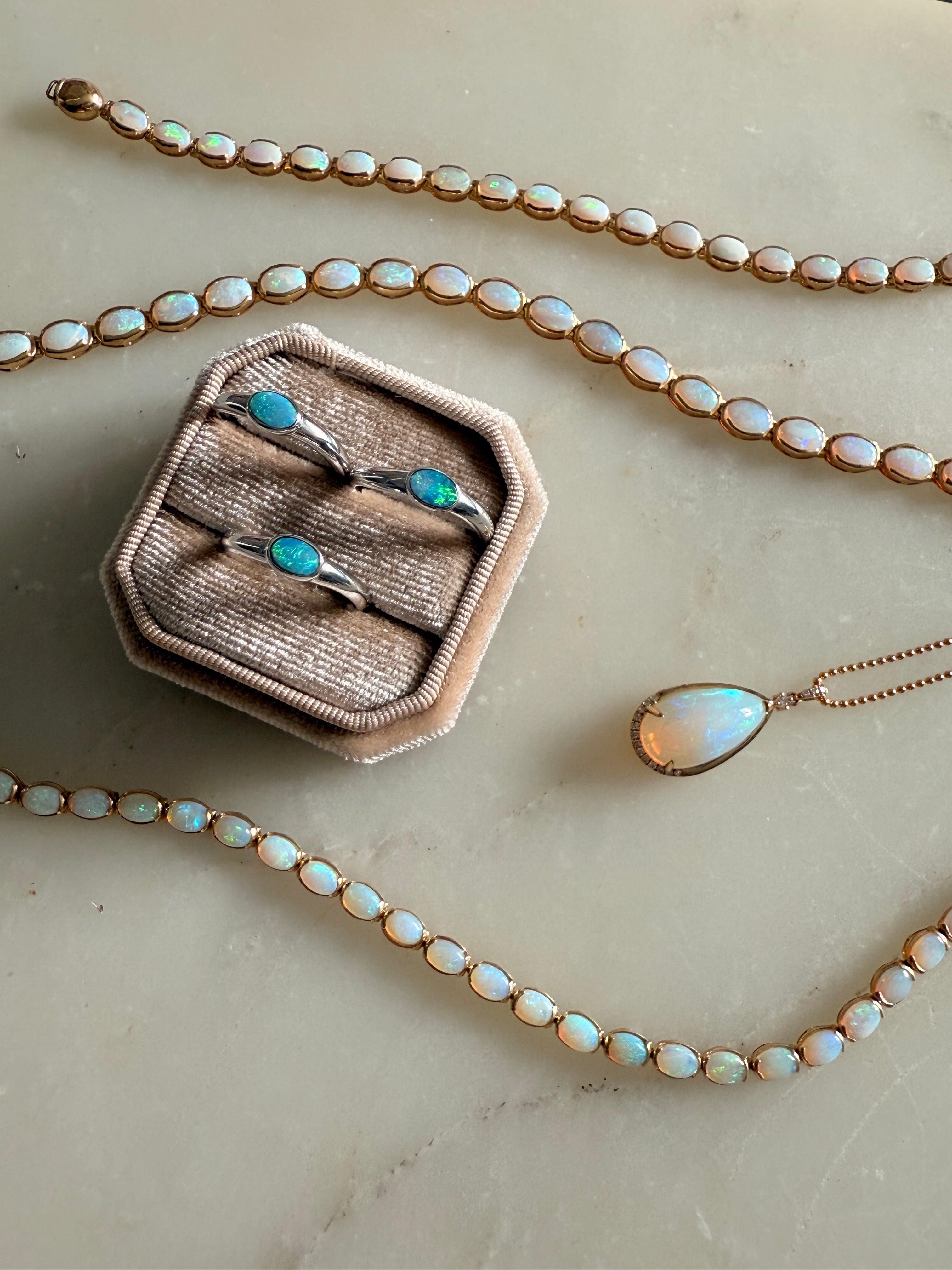 Jewelry being laid down on the table and inside a box