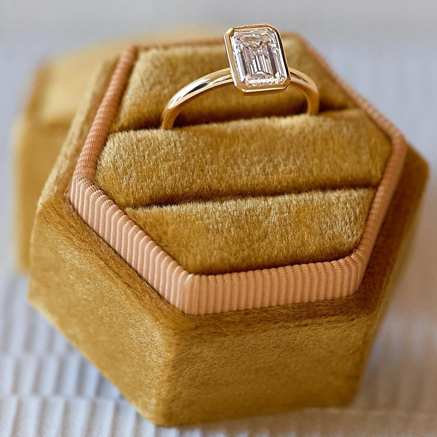 Bezel 14K solid yellow gold ring with a 1.73 carat emerald cut bezel set diamond
