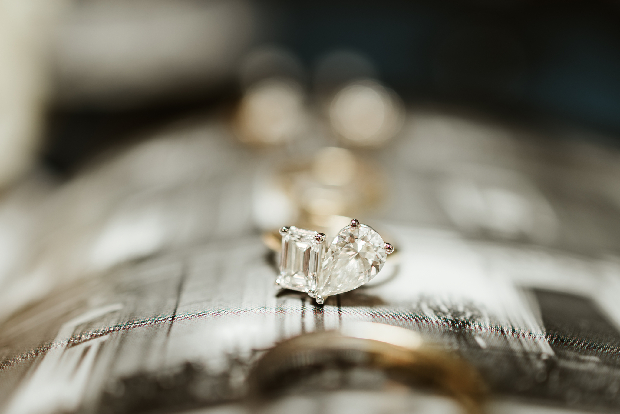 Diamond engagement ring by Vinca being laid out on a metal table